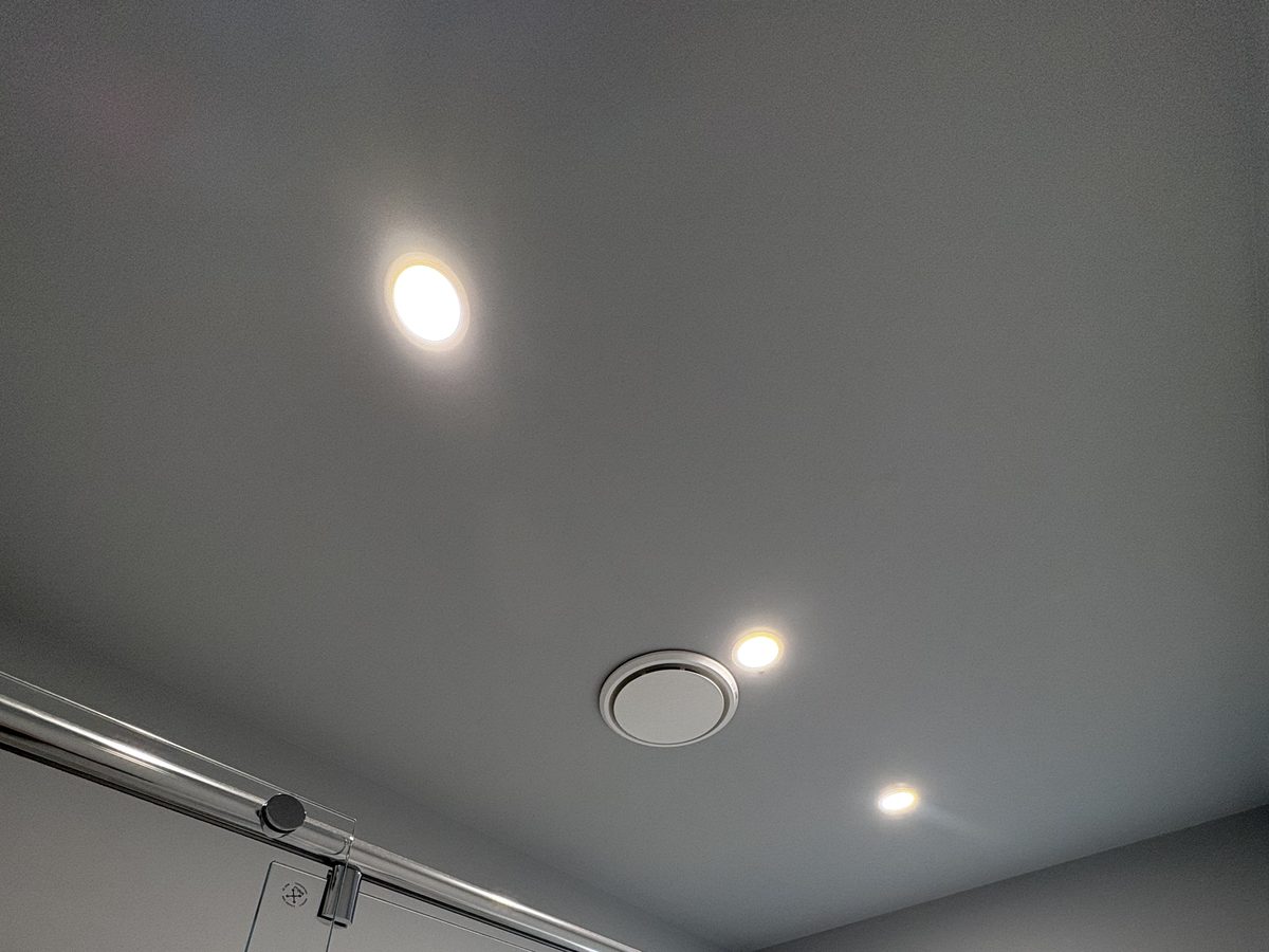 Three LED downlights and a ceiling exhaust fan installed in a renovated Williamstown bathroom