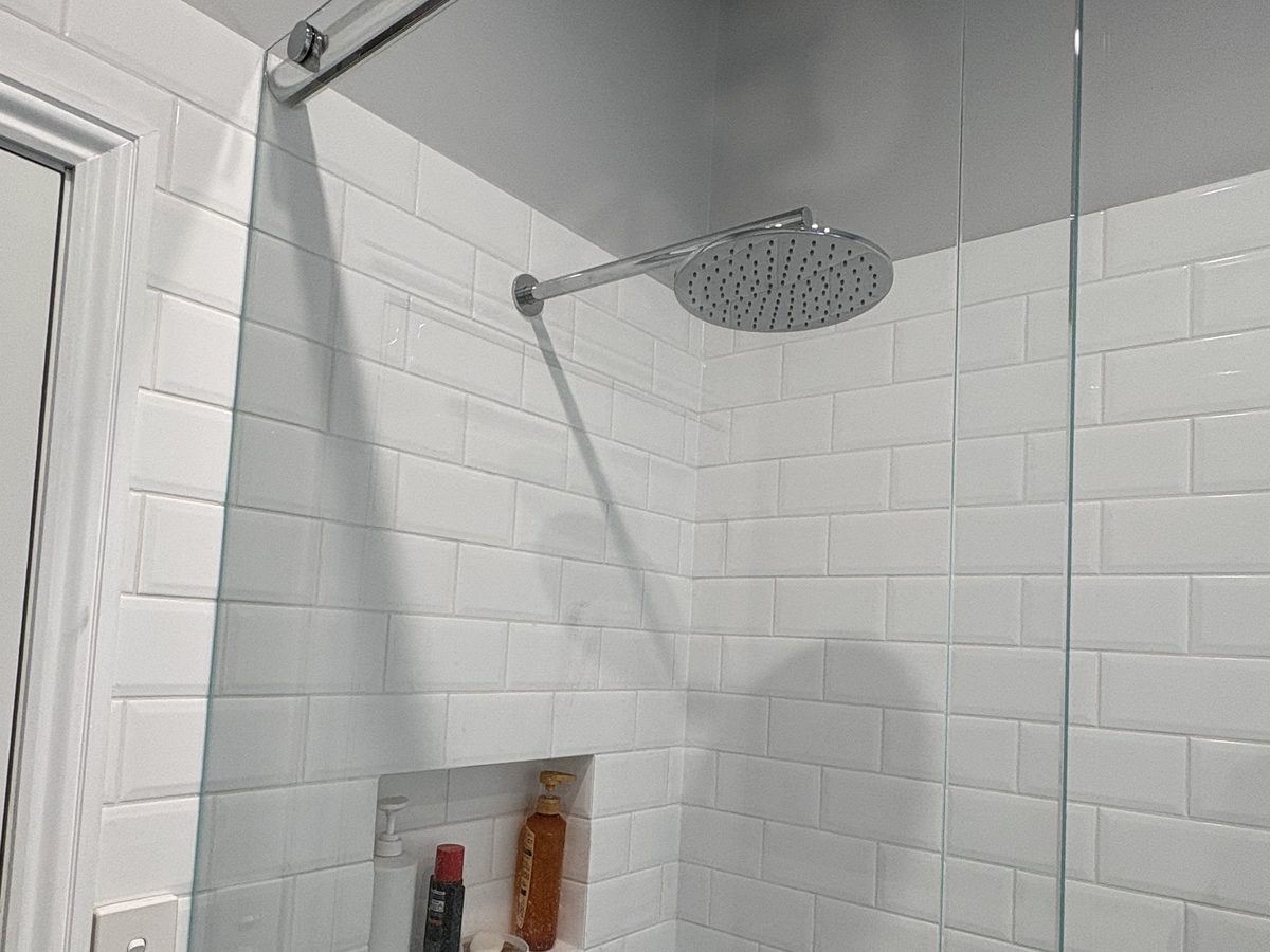 Renovated shower with subway tiling and a rain shower head, Williamstown bathroom