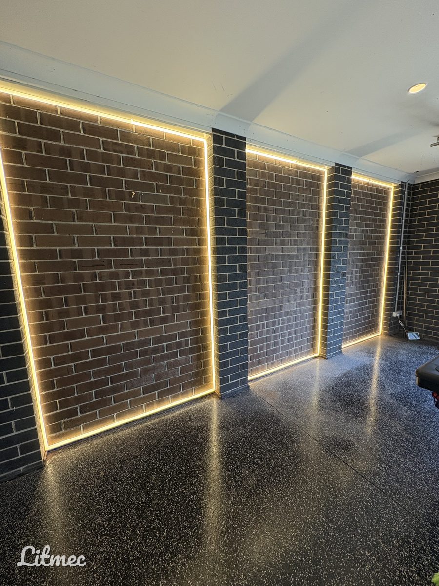 Three LED strip feature walls lighting exposed brick in a Yarraville garage