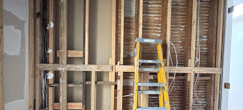 Domestic rough-in by Litmec Electrical — new cabling run through opened-up wall framing
